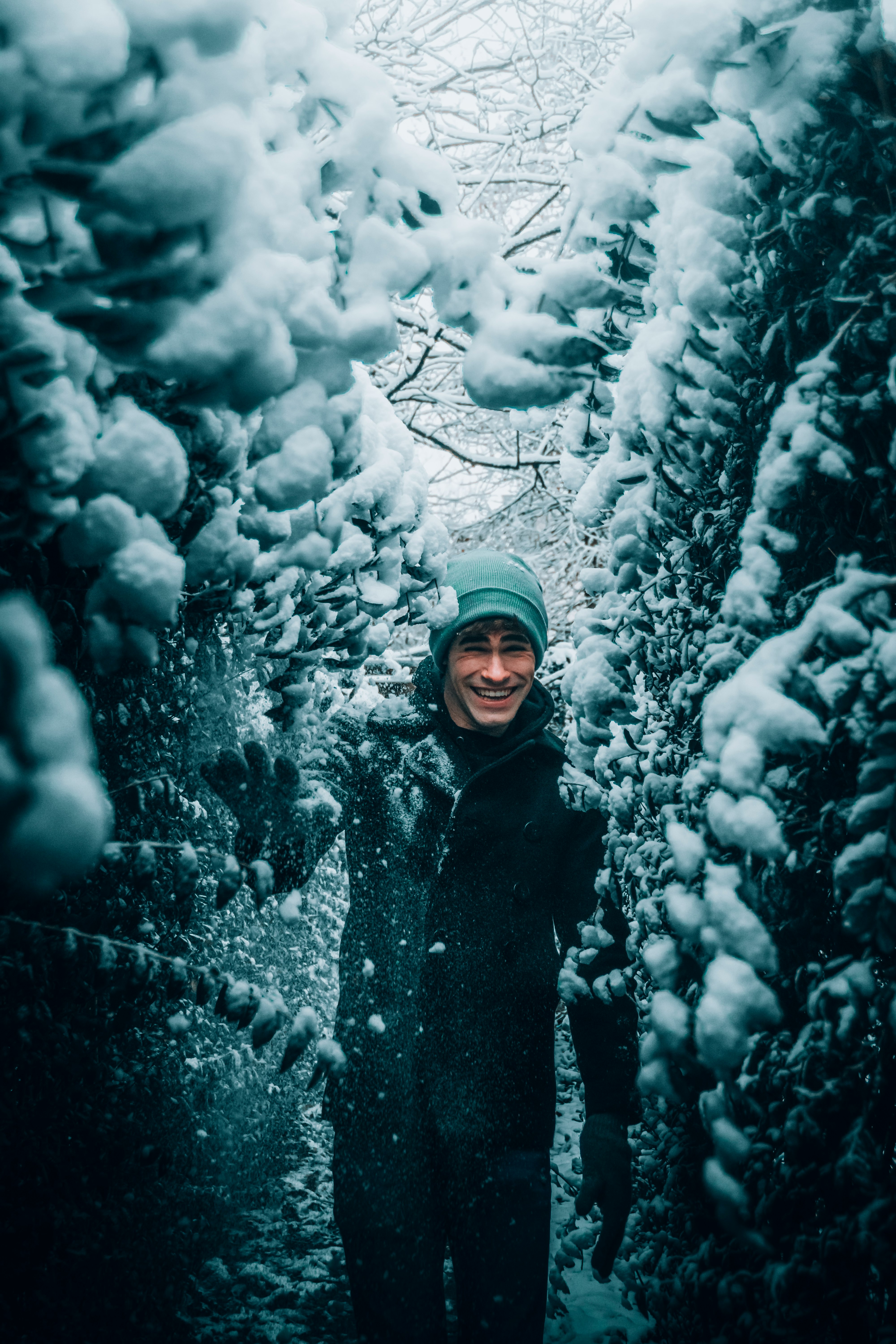 woman in black coat standing on snow covered ground